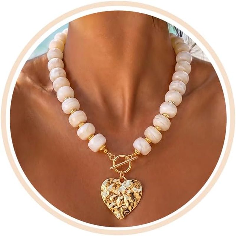 Chunky Beaded Statement Necklace with heart and cross charms styled for summer coastal outfits