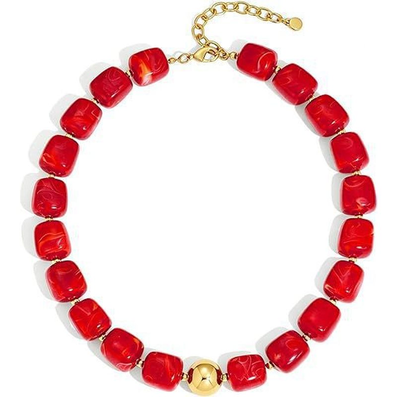 Model wearing colorful chunky beaded statement choker necklace on sunny beach